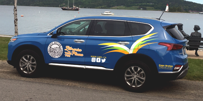 Image of Victoria County Outreach vehicle: a blue Hyundai Santa Fe with Cape Breton Regional Library brand images.