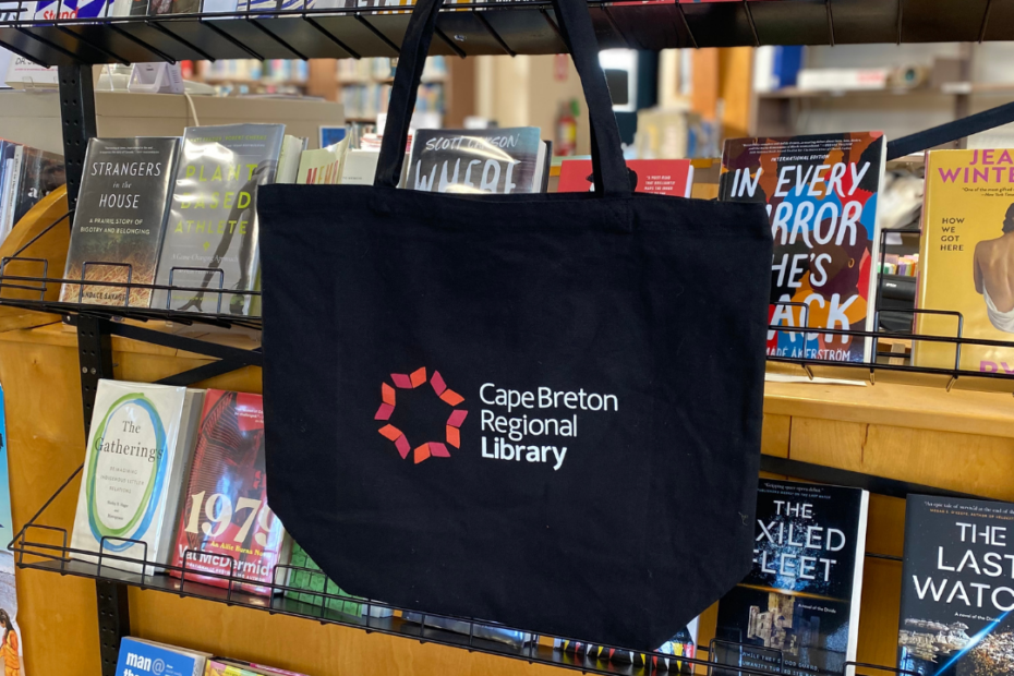cbrl tote bag in front of a shelf of books