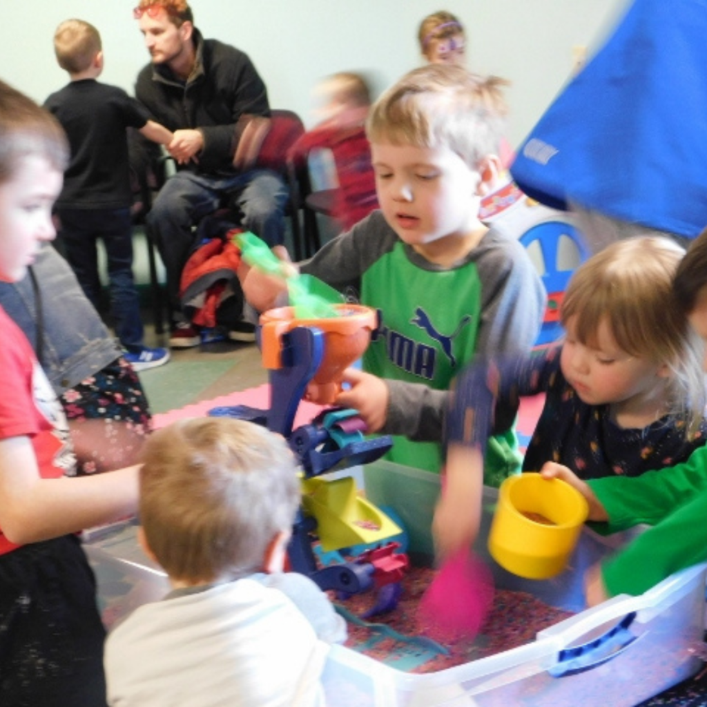 young children playing at a sensory bin