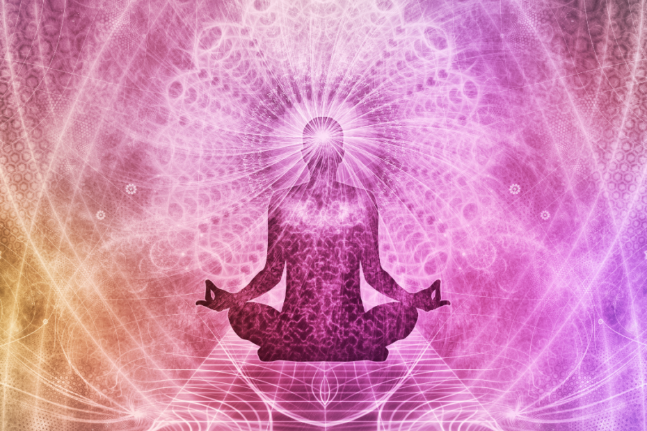 silhouette of person sitting cross-legged and meditating on a mystical pink, yellow, mandala inspired background.