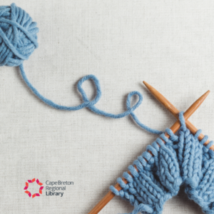 Photograph of two knitting needles with a small band of blue knitting on them.
