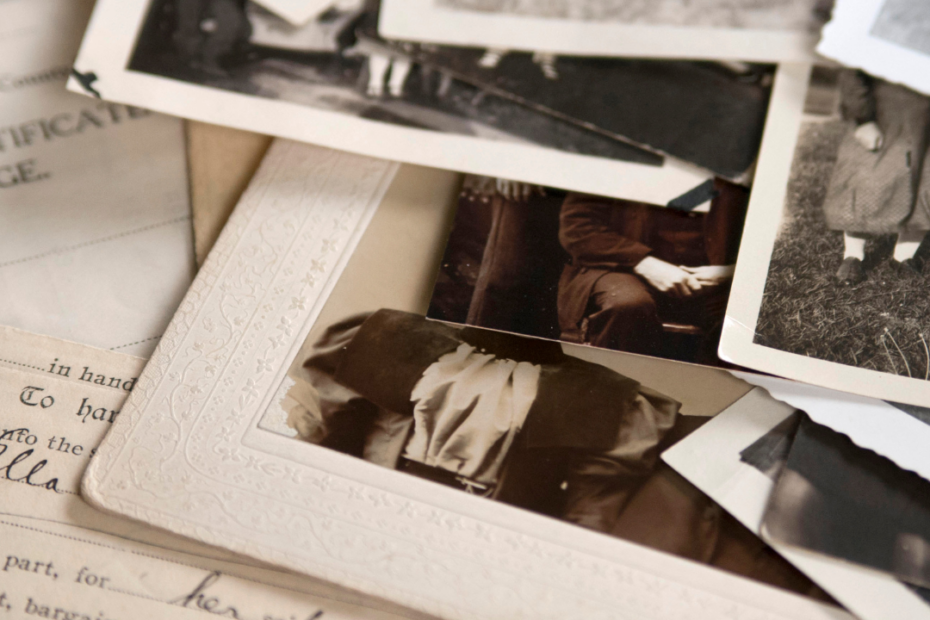 scattered black and white photographs and handwritten documents