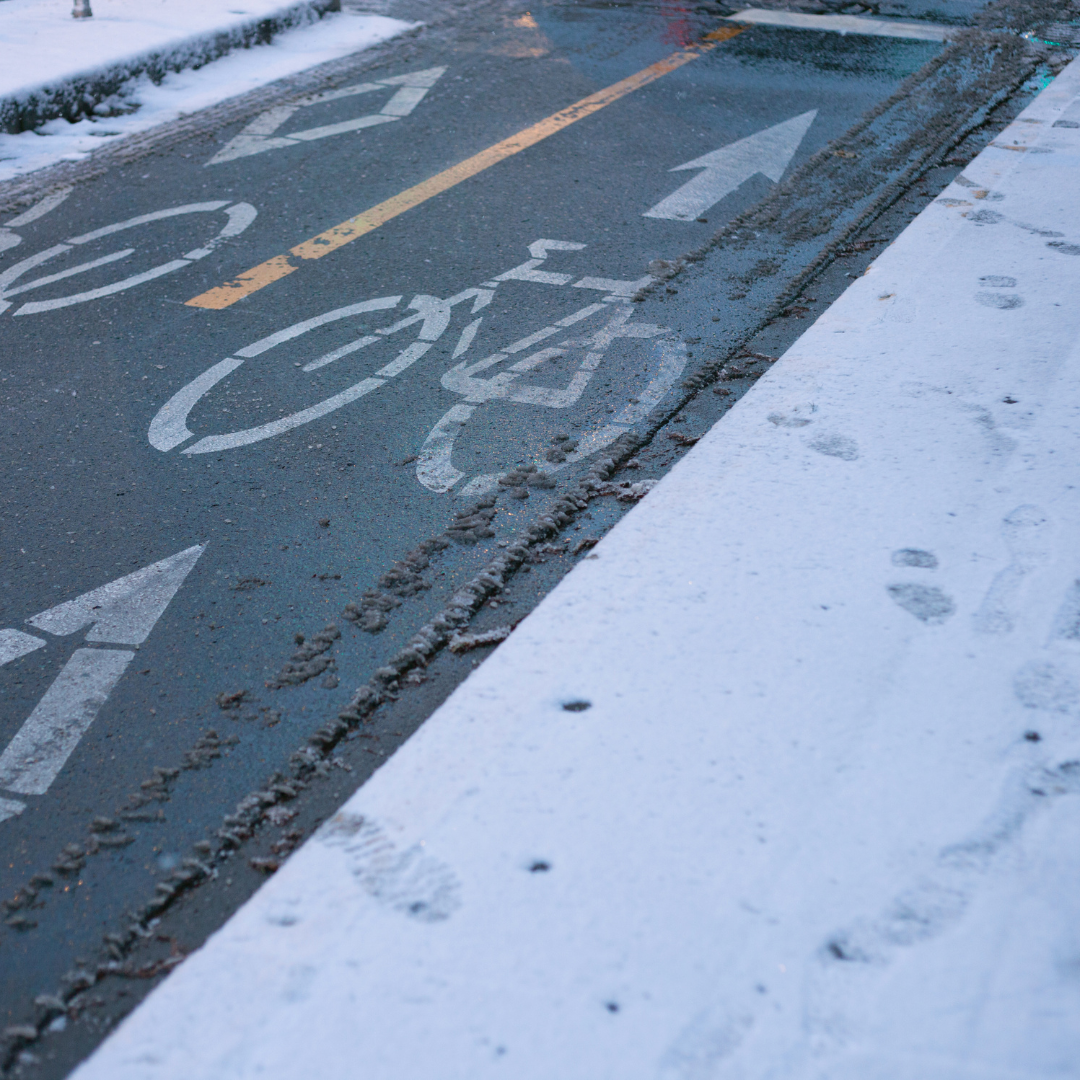 Plowed Bike lane in the winter, surrounded by snow.