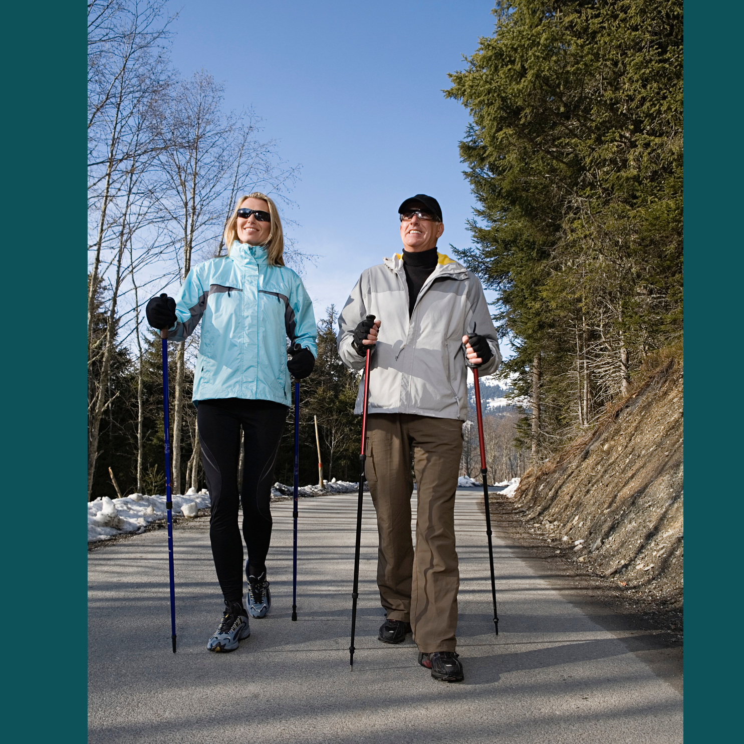 Two adults walking with nordic walking poles.