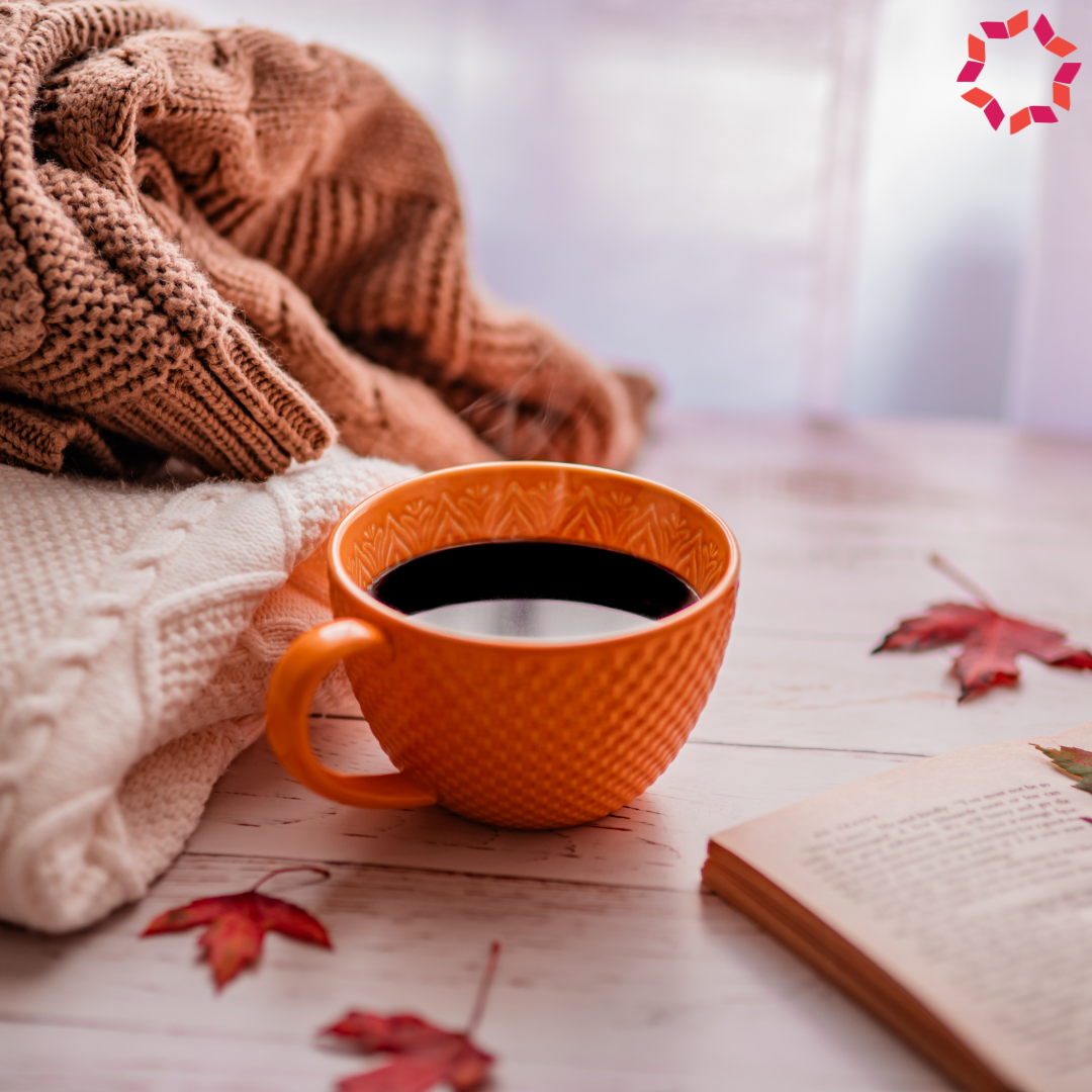 Cozy sweaters, a teacup and a book.